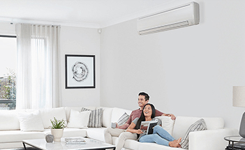 Couple enjoying Fujitsu air conditioning in their lounge room
